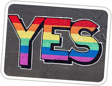 Mural of the word YES in rainbow stripes on a grey brick wall in Redfern, Sydney, September 2017